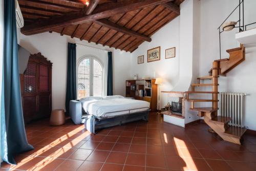 a bedroom with a bed and a spiral staircase at Cooker Chianti in Florence