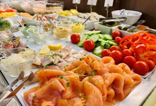 a table with many different types of food on it at Boutique Hotel Dom - Rooms & Suites in Graz