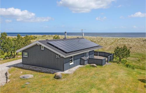 a house with a solar roof on the beach at Holiday Home Sæby With Fireplace 01 in Sæby