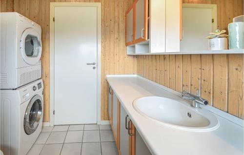 a bathroom with a sink and a washing machine at Lovely Home In Thisted With Wifi in Klitmøller