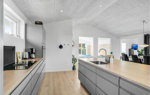 a kitchen with white walls and a wooden counter top at Lovely Home In Thisted With Sauna in Thisted