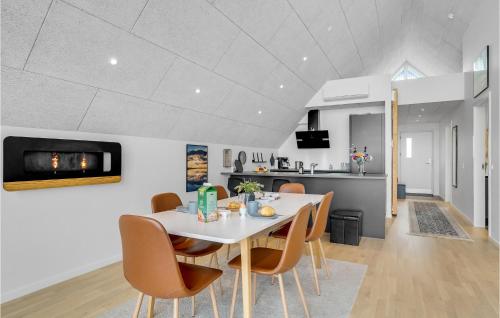 a kitchen and dining room with a white table and chairs at Stunning Apartment In Thisted With Wifi in Thisted
