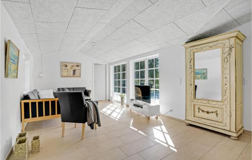 a living room with a mirror and a couch at 4 Bedroom Amazing Home In Hurup Thy in Sønder Ydby