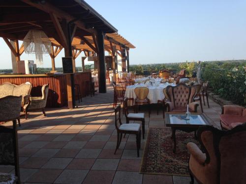 a restaurant with tables and chairs on a patio at Grand Hotel Forlì in Forlì