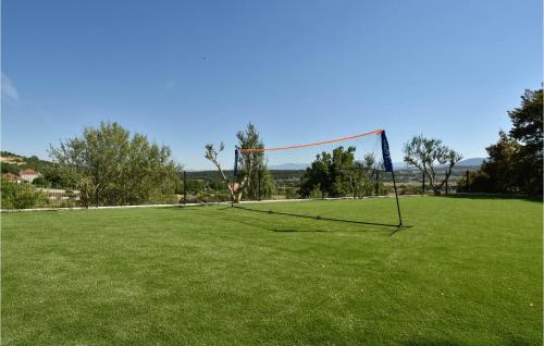 a net on a grass field with a goal at Stunning Home In Obrovac Sinjski in Obrovac Sinjski