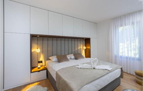 a bedroom with two beds with towels on them at Stunning Home In Obrovac Sinjski in Obrovac Sinjski