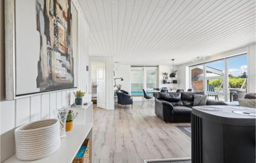 a living room with a couch and a table at Amazing Home In Ringkøbing With Sauna in Ringkøbing