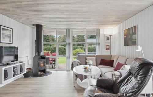 a living room with a couch and a fireplace at 3 Bedroom Nice Home In Hals in Hals