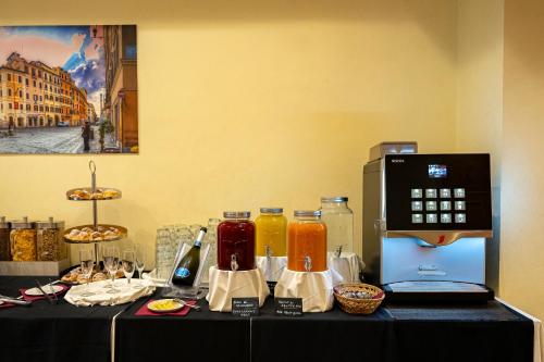 a table with bottles of juice and a microwave at Hotel San Remo in Rome