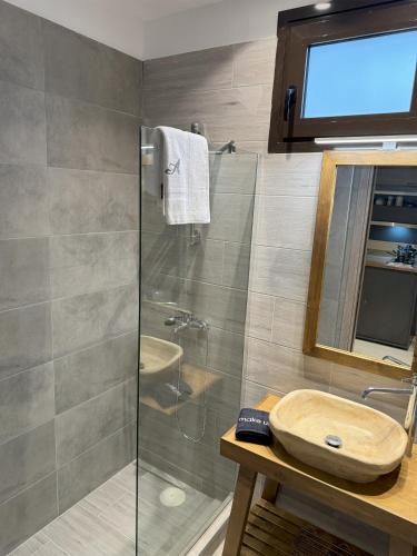 a bathroom with a glass shower and a sink at Alafe Relax & View in Synikia Mesi Trikalon