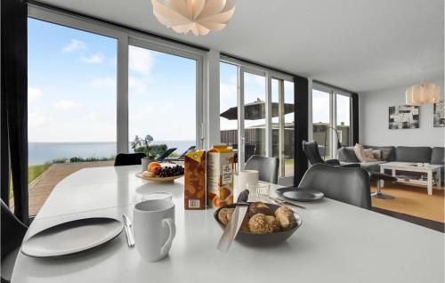a white table with a bowl of food on it at Holiday Home Kelstrup Klint Haderslev Iii in Kelstrup