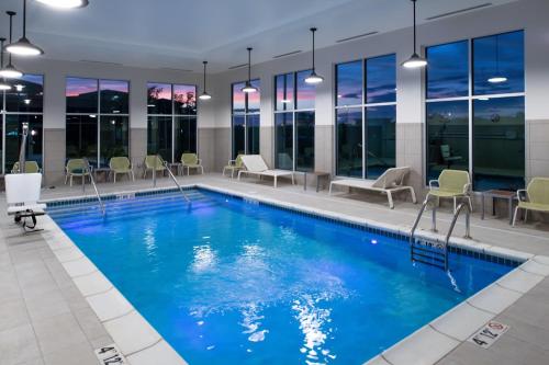 a pool with blue water in a building at Element Kansas City Overland Park in Leawood
