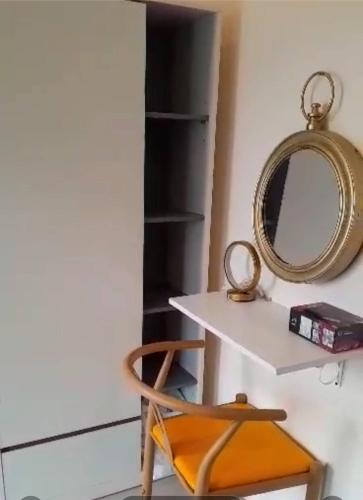 a dressing table with a mirror and a chair at ขุนโลหะ in Phuket Town