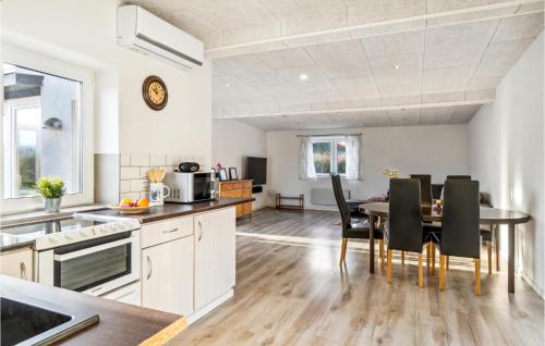 a kitchen and dining room with a table and chairs at Nice Home In Roslev With Wifi in Roslev