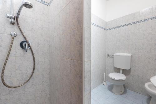 a bathroom with a shower and a toilet at Casa Emilia - cozy apartment in Parma in Parma
