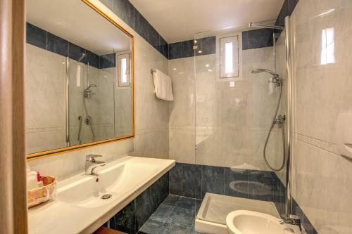 a bathroom with a sink and a shower and a toilet at Hotel San Remo in Rome