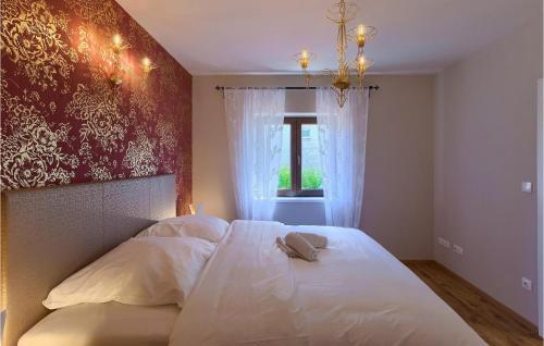 a bedroom with a bed with a hat on it at Villa Botanica Istria in Poreč