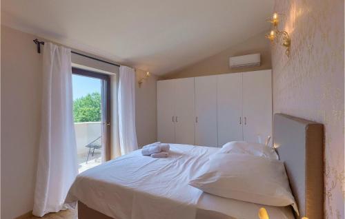 a bedroom with a bed and a large window at Villa Botanica Istria in Poreč