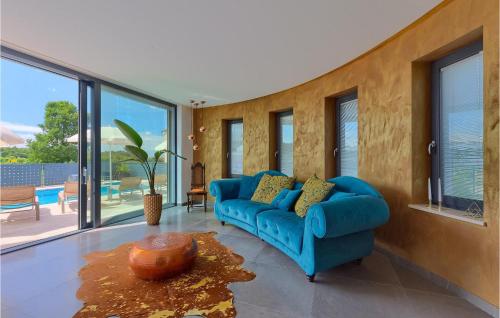 a living room with a blue couch and windows at Villa Aria in Poreč