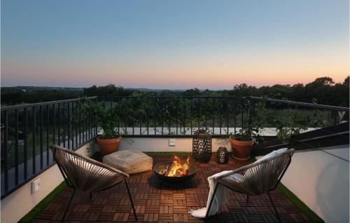 a patio with a fire pit on a balcony at Villa Eco in Orbani