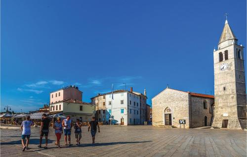 a group of people standing in front of a clock tower at Awesome Home In Fazana With Kitchen in Fažana