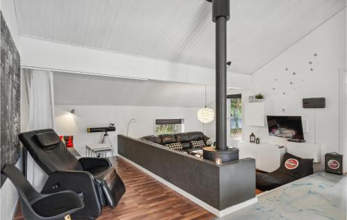 a living room with a couch and a fireplace at 4 Bedroom Cozy Home In Brovst in Brovst