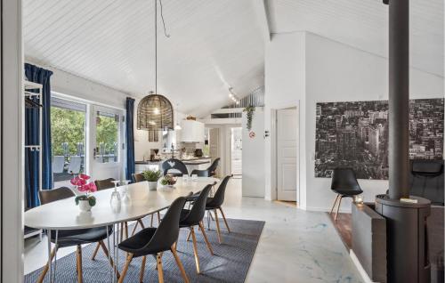a dining room with a white table and chairs at 4 Bedroom Cozy Home In Brovst in Brovst