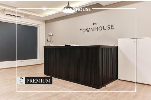 a black desk in a room with a black and white wall at Townhouse D- Knowledge Park III in Noida