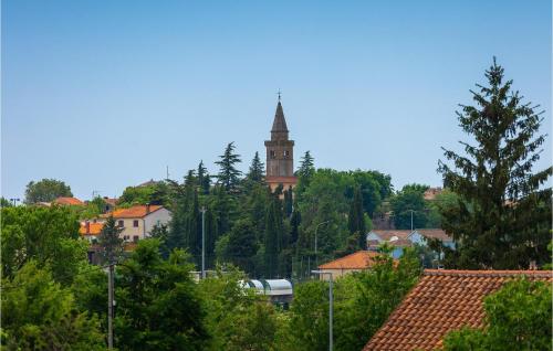 a tall clock tower with a steeple in a city at Villa Kate in Žminj