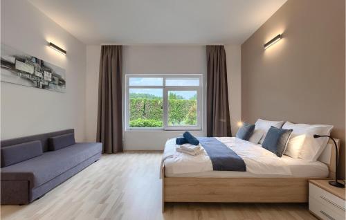 a bedroom with a bed and a couch and a window at Villa Kate in Žminj