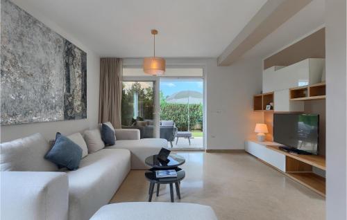 a living room with a white couch and a tv at Villa Kate in Žminj