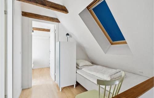 a small room with a bed and a window at Cozy Home In Assens With Wifi in Assens