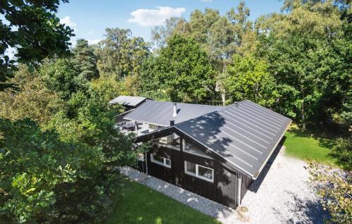 an overhead view of a black house in the woods at Holiday Home Hægvej Grenaa Xi in Grenå