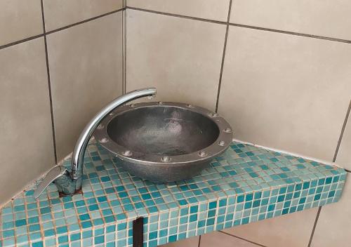 a metal sink on a tiled counter in a bathroom at Imbabali Retreat & Venue in Magaliesburg