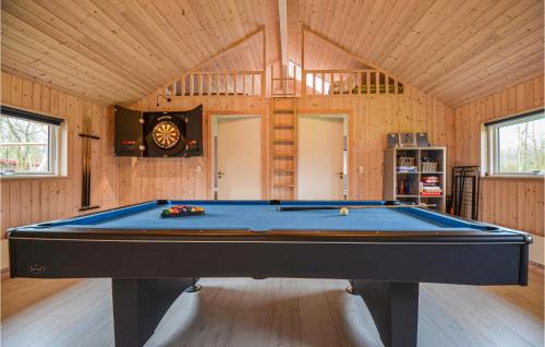 a pool table in a room with wooden walls at Four-Bedroom Holiday Home Glesborg With A Room Hot Tub 07 in Fjellerup