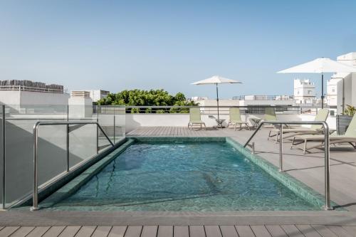 a swimming pool on the roof of a building at BYPILLOW La Sal in Cádiz