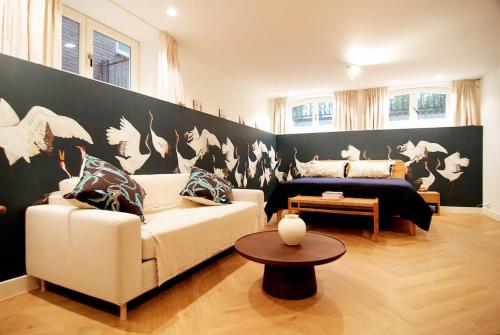 a living room with a couch and a bed at Spacious Suite at Park and Museum in Amsterdam