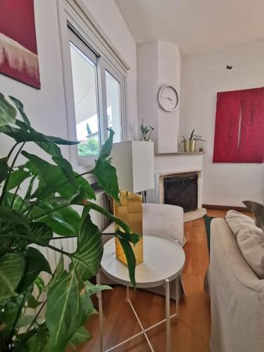 a living room with a table and a plant at Cozy Family Home in Laxia