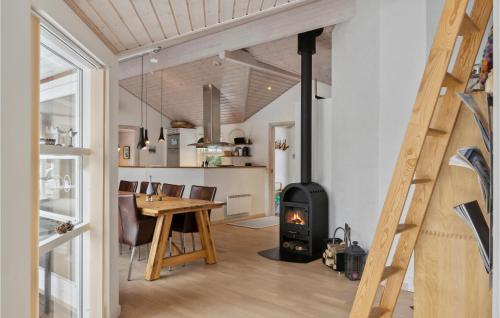 a room with a table and a wood stove at Holiday Home Kuskevej Jerup Iv in Jerup