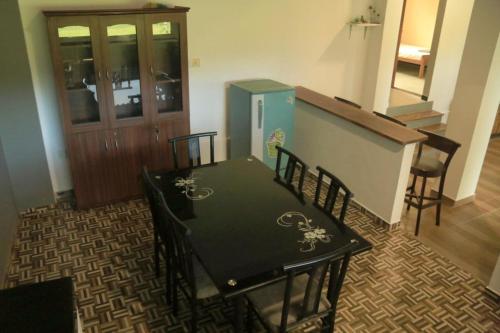 a room with a table and chairs and a door at Paddy Field Paradise by Sri Villa Rest in Hikkaduwa