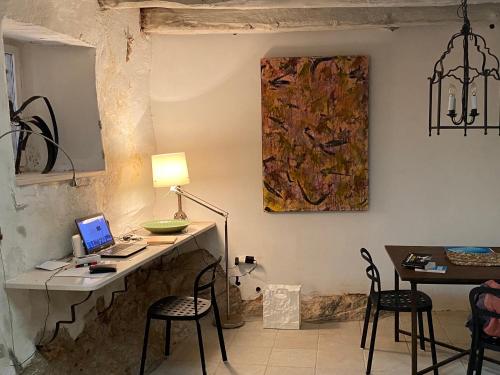 a room with a desk with a laptop and chairs at Maison Marmont in Vela Luka