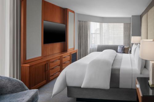 a hotel room with a bed and a flat screen tv at The Westin New York Grand Central in New York