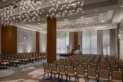 an empty hall with rows of chairs and a chandelier at The Westin New York Grand Central in New York