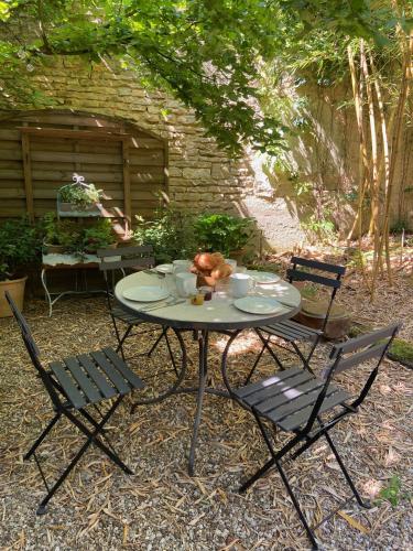 a table with two chairs and a table with food on it at Gîte d'exception - Manoir de Sacquenay in Sacquenay