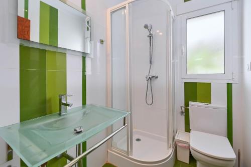 a bathroom with a sink and a shower and a toilet at Villa Angels in Teulada