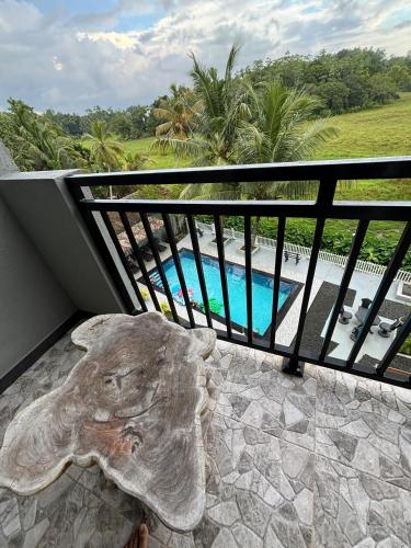 an elephant statue sitting on a balcony next to a pool at Paddy Field Paradise by Sri Villa Rest in Hikkaduwa