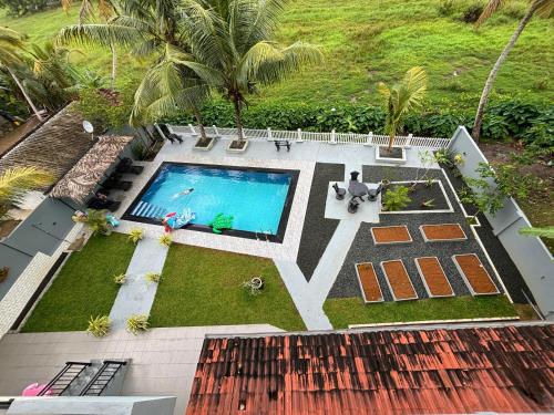 an aerial view of a backyard with a swimming pool at Paddy Field Paradise by Sri Villa Rest in Hikkaduwa