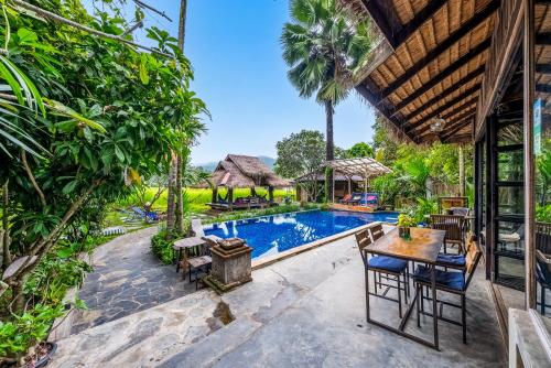 an exterior view of a villa with a swimming pool at Buzzas @ Pai Chan in Pai