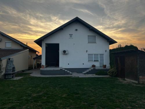 a white house with a dark roof at Kuća za odmor „Slavonska Lola“ in Nuštar