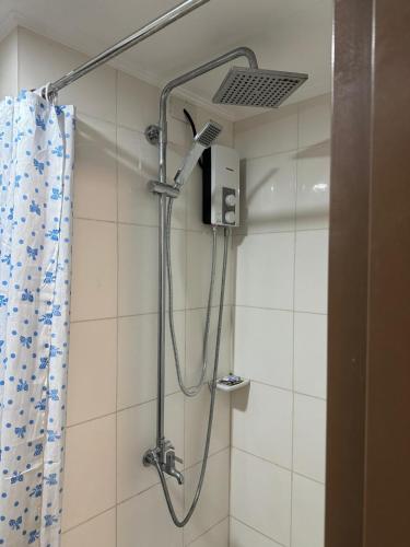 a shower with a shower head in a bathroom at Cagayan de oro One Oasis - 2 Bedroom Unit in Cagayan de Oro